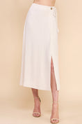 Load image into Gallery viewer, Dove Linen Wrap Midi Skirt in Natural. Features a soft linen-blend fabric, side tie closure, and elegant wrap design for a flattering and breathable fit.