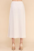 Load image into Gallery viewer, Back view of the Dove Linen Wrap Midi Skirt in Natural, showcasing the effortless drape and silhouette.