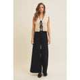 Load image into Gallery viewer, Charming Gabriela Crochet Sweater Vest featuring delicate scalloped edges, front bow tie, and sleeveless design in natural/black, ideal for warm-weather styling.