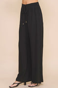 Load image into Gallery viewer, Side-view of Jessica Linen Blend Pants showing smocked waist detail and functional pockets in breathable linen-cotton fabric.