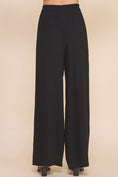 Load image into Gallery viewer, Jessica Linen Blend Pants in wide-leg style, offering a relaxed fit with smocked waist and side pockets for comfort.