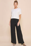 Load image into Gallery viewer, Model wearing Jessica Linen Blend Pants with a wide-leg fit and smocked waist, styled for a chic spring look.