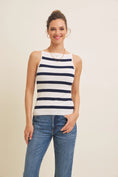Load image into Gallery viewer, Model wearing a navy and white striped boat neck tank top made from soft, stretchy sweater fabric. It is paired with blue jeans for a casual, comfortable outfit. A versatile staple for effortless styling.
